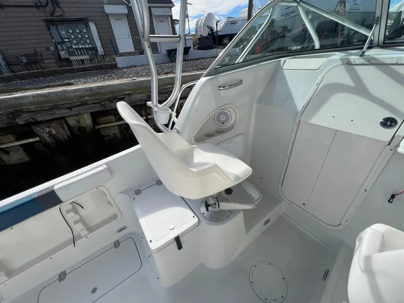 Slide: The Image of 2005 Sailfish 234 WAC boat interior with white seating and console. - 19