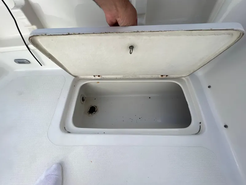 Slide: The Image of Open storage compartment on a 2005 Sailfish 234 WAC boat deck. - 23