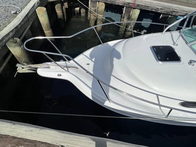 Slide: The Image of 2005 Sailfish 234 WAC boat docked at a wooden pier. - 5