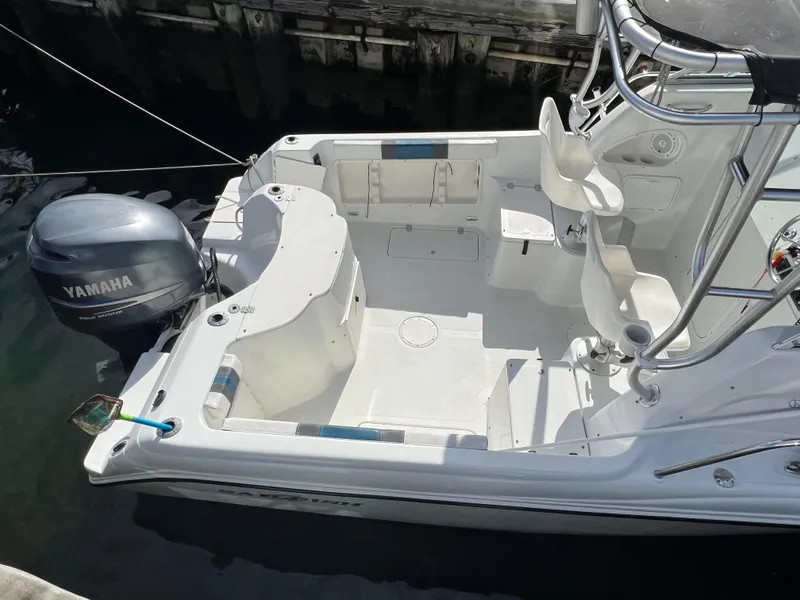 Slide: The Image of 2005 Sailfish 234 WAC boat with Yamaha outboard motor, docked in a marina. - 7