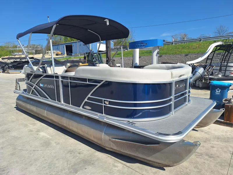 The Image of 2024 Sylvan Mirage Cruise 8520 CLZ DH pontoon boat with canopy, docked outdoors. - 0