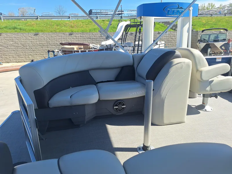 Slide: The Image of 2024 Sylvan Mirage Cruise 8520 CLZ DH pontoon boat interior with plush seating. - 10