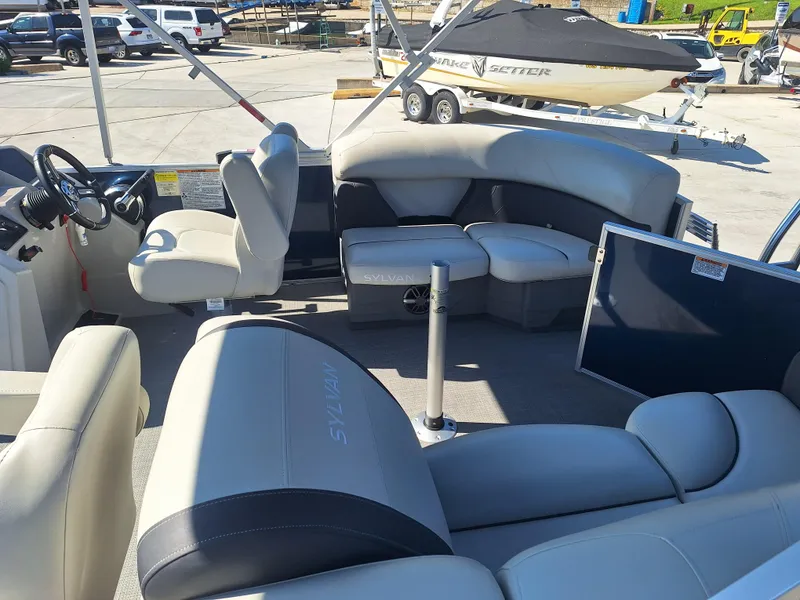 Slide: The Image of 2024 Sylvan Mirage Cruise 8520 CLZ DH pontoon boat interior with seating and steering console. - 15