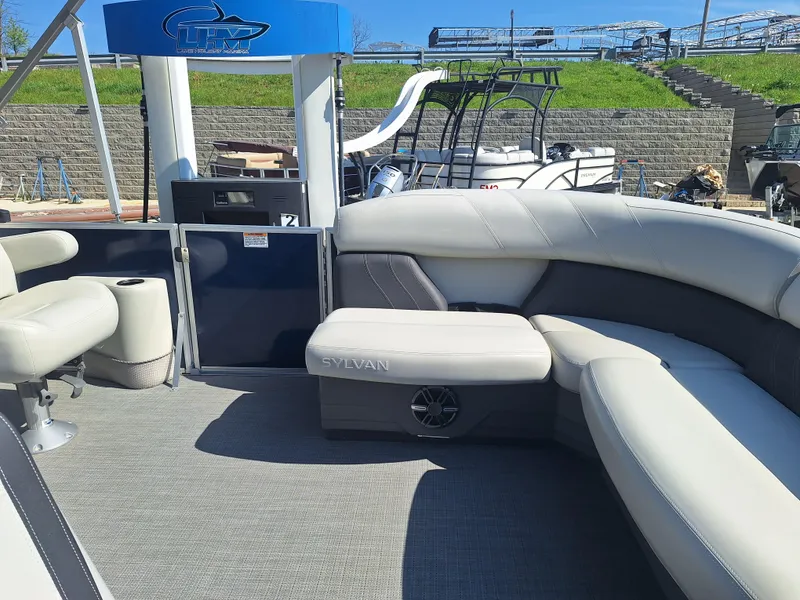 Slide: The Image of 2024 Sylvan Mirage Cruise 8520 CLZ DH pontoon boat interior with plush seating. - 11