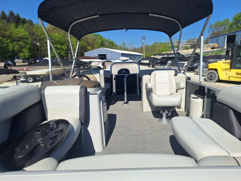 Slide: The Image of 2024 Sylvan Mirage Cruise 8520 CLZ DH pontoon boat interior with seating and canopy. - 12