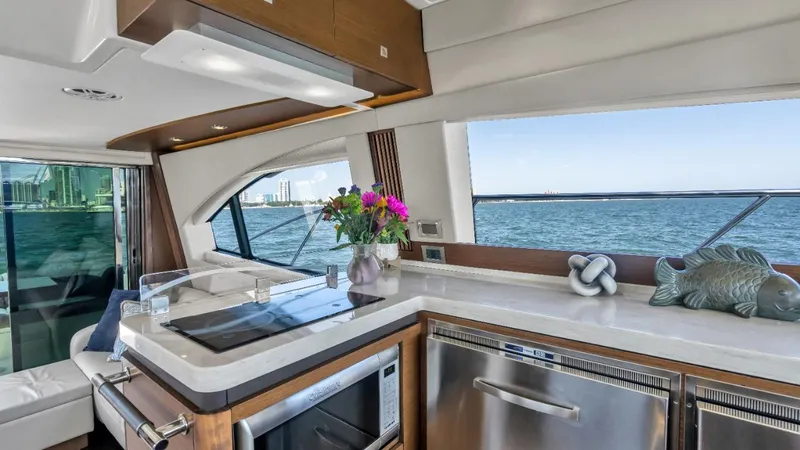 Slide: The Image of Luxurious interior of 2015 Sea Ray 510 Fly yacht with modern kitchen and ocean view. - 16