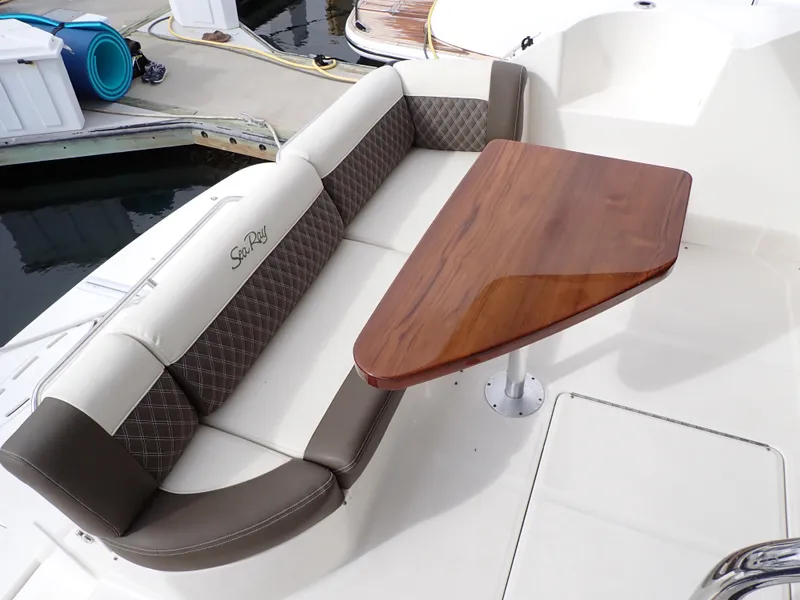 Slide: The Image of Luxurious seating area on a 2015 Sea Ray 510 Fly yacht with a wooden table. - 23