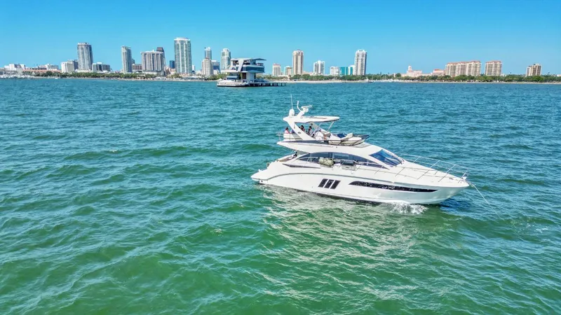 Slide: The Image of 2015 Sea Ray 510 Fly yacht cruising near city skyline on a sunny day. - 3