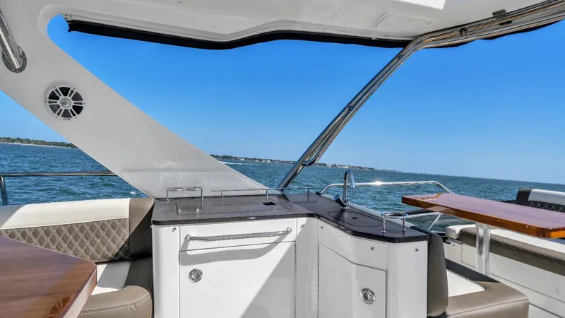 Slide: The Image of 2015 Sea Ray 510 Fly yacht interior with ocean view, featuring sleek design and modern amenities. - 5