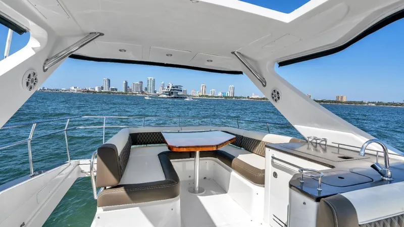 Slide: The Image of Luxurious 2015 Sea Ray 510 Fly yacht interior with ocean view and city skyline. - 6