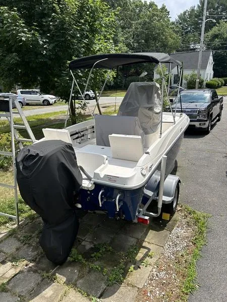 Slide: The Image of 2017 Bayliner Element F18 CC boat on trailer, parked in driveway. - 9