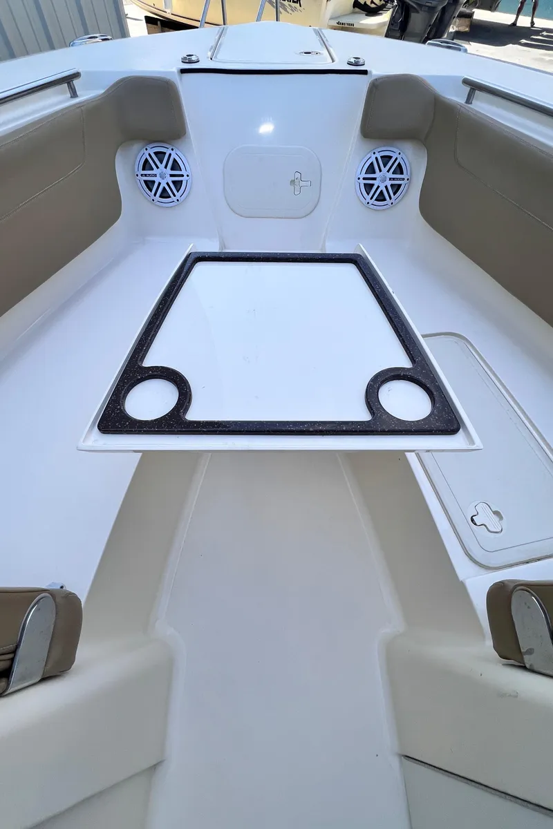 Slide: The Image of 2018 Scout 275 Dorado boat interior with seating and cup holders. - 10