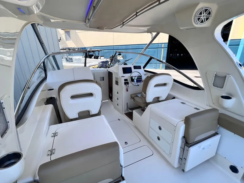Slide: The Image of 2018 Scout 275 Dorado boat interior with beige seating and modern dashboard. - 4
