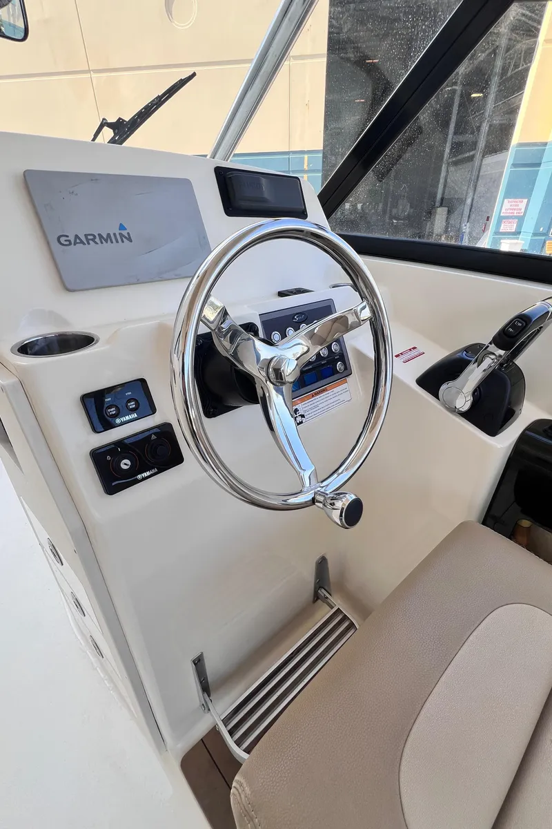 Slide: The Image of Steering wheel and controls of 2018 Scout 275 Dorado boat with Garmin display. - 7