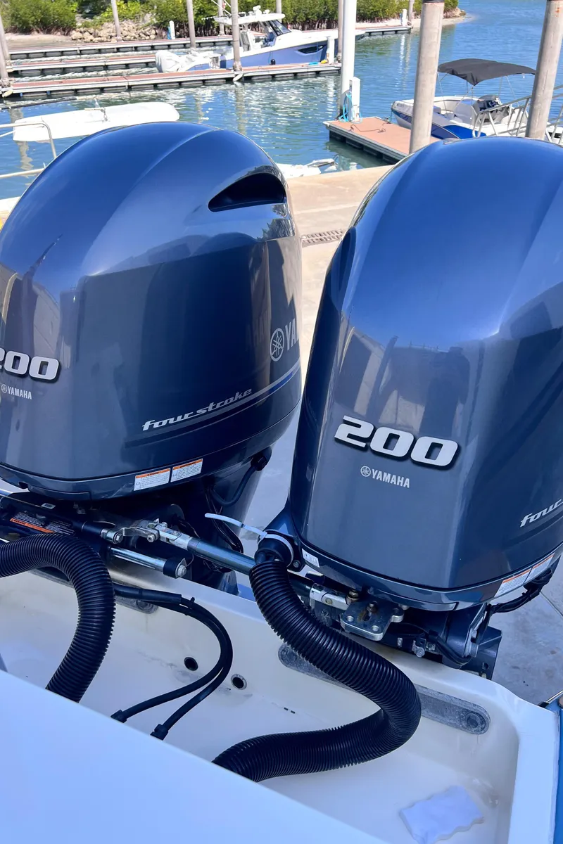 Slide: The Image of Twin Yamaha 200 engines on a 2018 Scout 275 Dorado boat at a marina. - 8