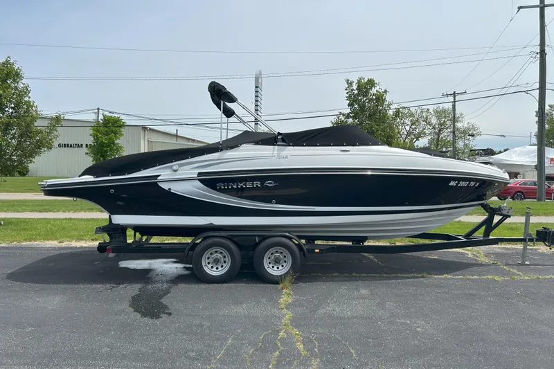 The Image of 2014 Rinker Captiva 246 BR boat on trailer, parked outdoors. - 0