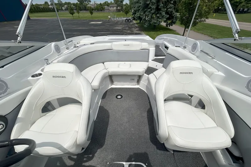 Slide: The Image of 2014 Rinker Captiva 246 BR boat interior with white seating and gray carpet. - 10