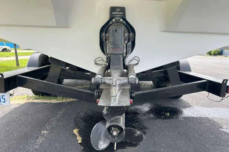 Slide: The Image of 2014 Rinker Captiva 246 BR boat on trailer, showing propeller and outdrive. - 3