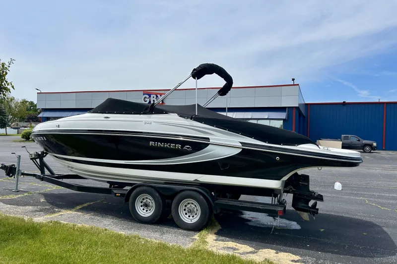Slide: The Image of 2014 Rinker Captiva 246 BR boat on trailer, parked outdoors. - 4
