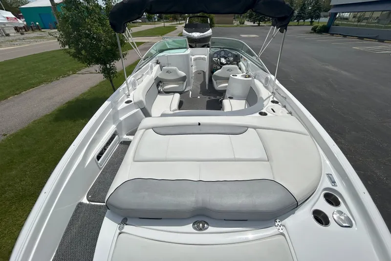 Slide: The Image of 2014 Rinker Captiva 246 BR boat with spacious seating and sleek design. - 5