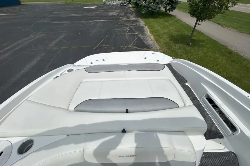 Slide: The Image of 2014 Rinker Captiva 246 BR boat with white seating and spacious deck. - 6