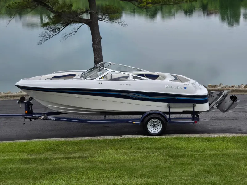 The Image of 1998 Four Winns Horizon RS RX boat on trailer by a lake. - 0
