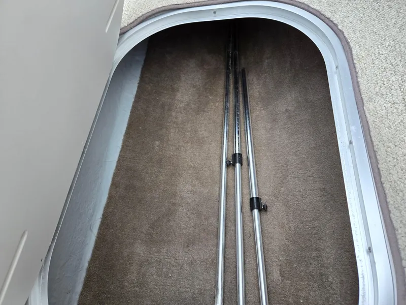 Slide: The Image of Storage compartment in 1998 Four Winns Horizon RS RX boat with metal rods inside. - 14