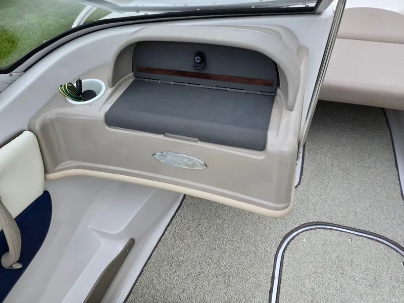 Slide: The Image of 1998 Four Winns Horizon RS RX boat interior with storage compartment and cup holder. - 15