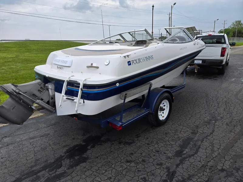 Slide: The Image of 1998 Four Winns Horizon RS RX boat on trailer, parked on paved road. - 3