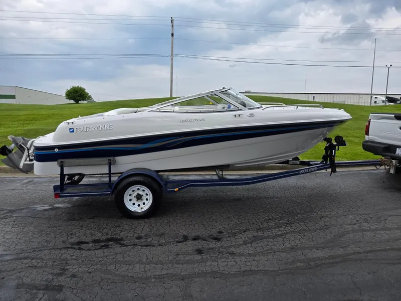 Slide: The Image of 1998 Four Winns Horizon RS RX boat on trailer, parked on asphalt road. - 4