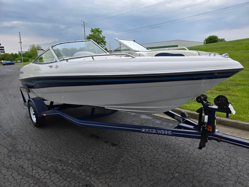 Slide: The Image of 1998 Four Winns Horizon RS RX boat on trailer, parked on paved road. - 5