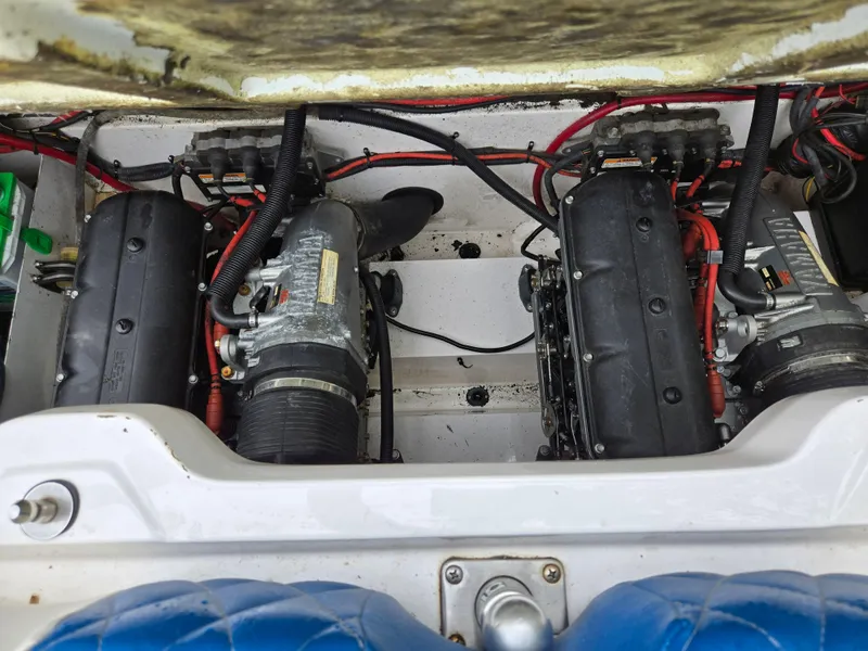 Slide: The Image of Engine compartment of a 2004 Yamaha Boats 210 LX, featuring dual engines and wiring. - 15