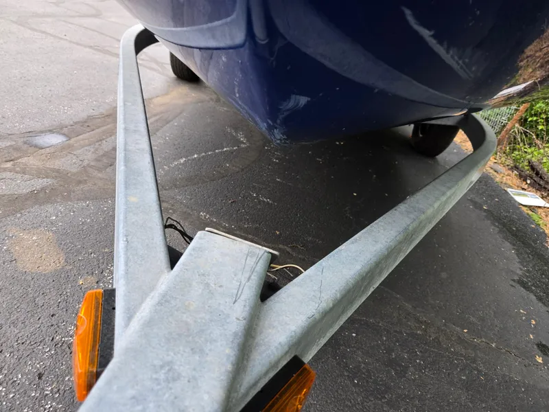 Slide: The Image of Trailer with 2004 Yamaha Boats 210 LX, parked on asphalt. - 7