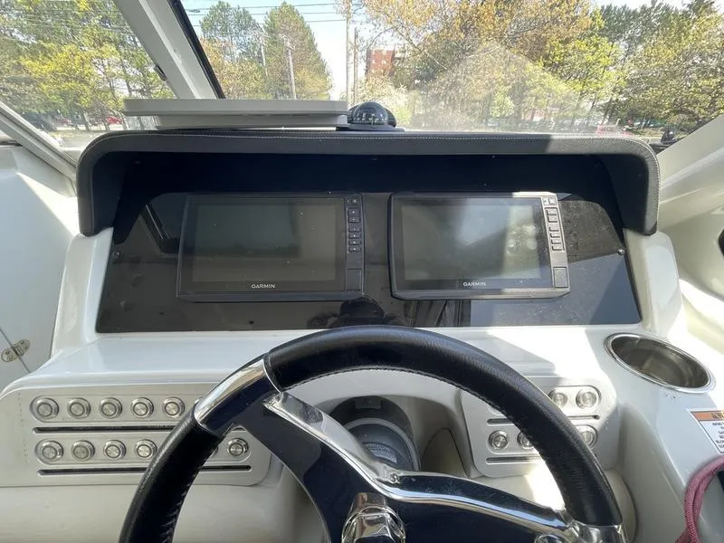 Slide: The Image of Cockpit of 2022 Finseeker 280 DC with dual Garmin displays and steering wheel. - 10