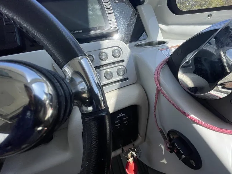 Slide: The Image of Cockpit view of 2022 Finseeker 280 DC boat with steering wheel and control panel. - 12
