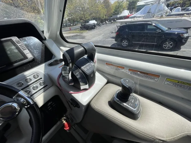 Slide: The Image of Cockpit view of 2022 Finseeker 280 DC boat with controls and dashboard. - 13