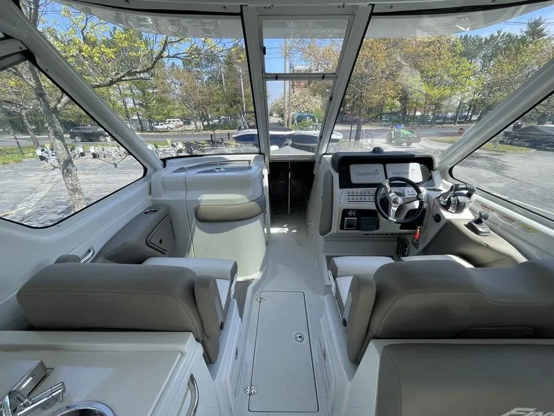 Slide: The Image of 2022 Finseeker 280 DC boat interior with modern dashboard and seating. - 2