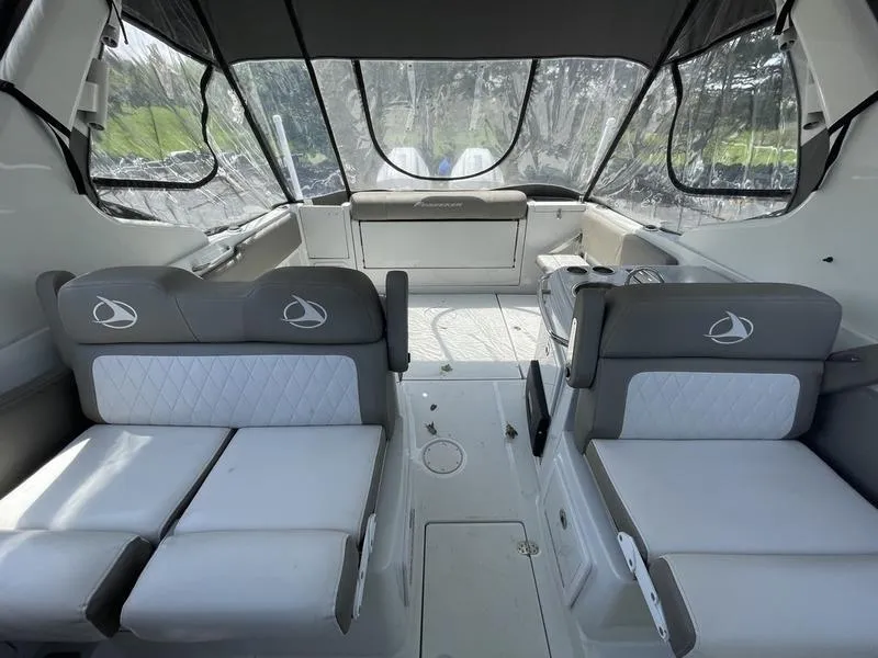 Slide: The Image of 2022 Finseeker 280 DC boat interior with cushioned seating and clear canopy. - 8