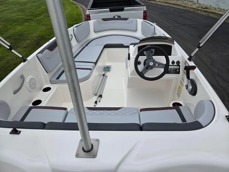 Slide: The Image of 2022 Bayliner Element M15 boat interior with seating and steering wheel. - 10