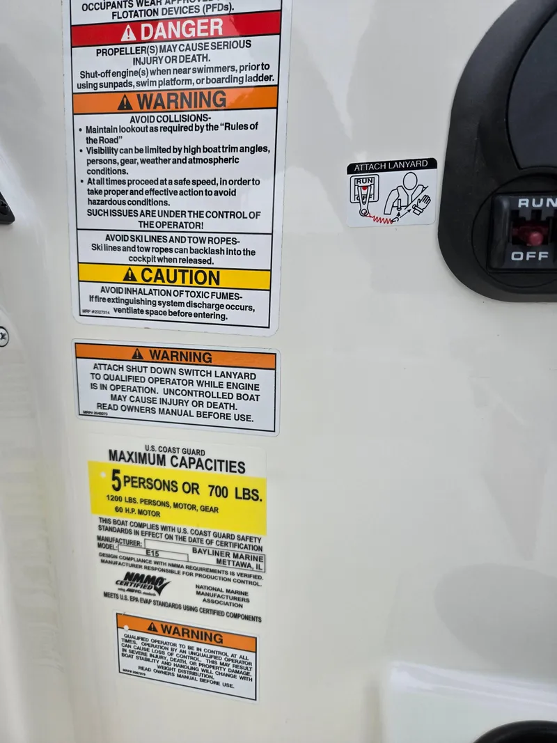 Slide: The Image of Warning labels on a 2022 Bayliner Element M15 boat, detailing safety and capacity information. - 11