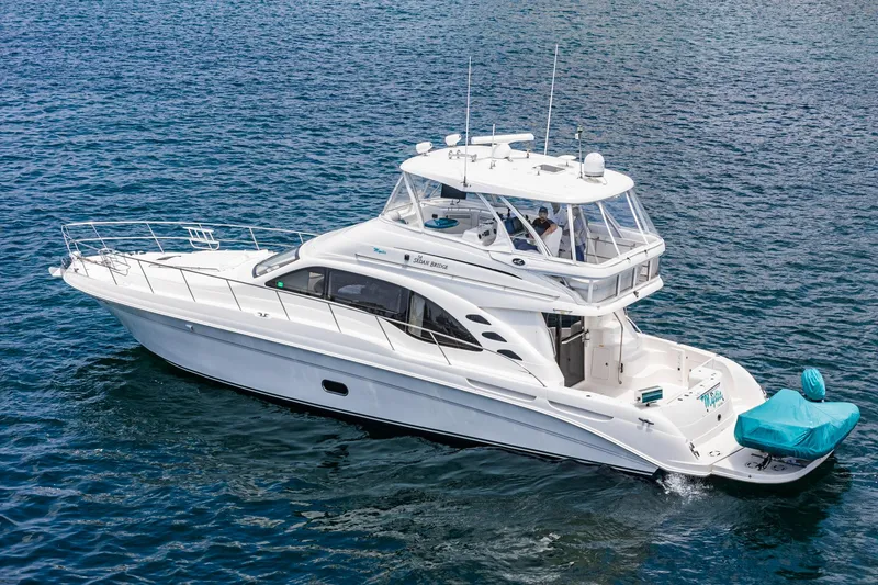 Slide: The Image of 2008 Sea Ray 58 Sedan Bridge yacht cruising on open water. - 13