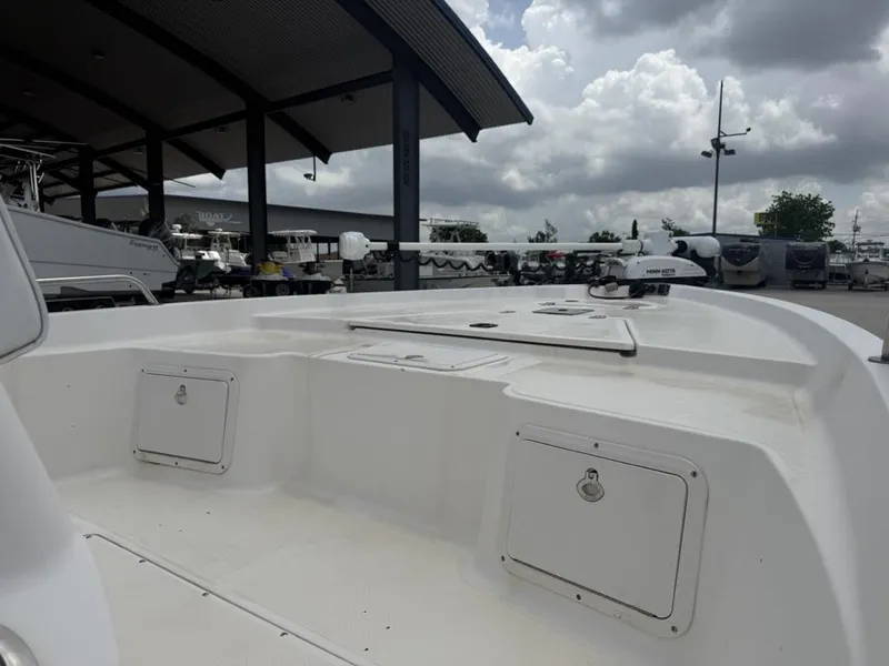 Slide: The Image of 2001 Key West 196 Bay Reef boat interior under cloudy sky at marina. - 11