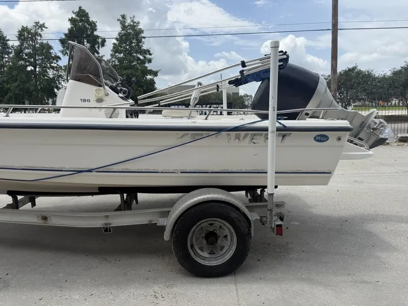 Slide: The Image of 2001 Key West 196 Bay Reef boat on trailer, side view, outdoors. - 3