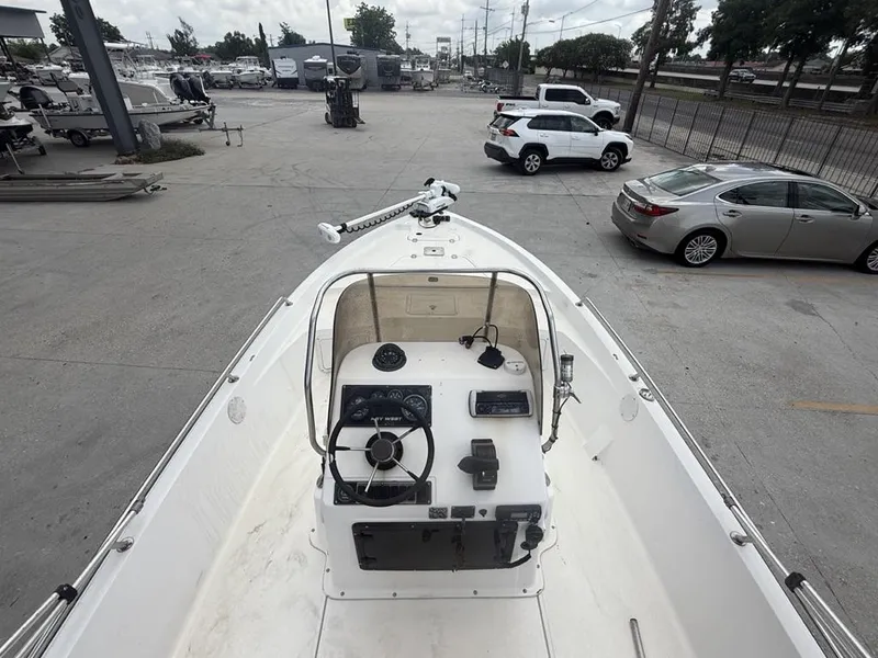 Slide: The Image of 2001 Key West 196 Bay Reef boat, view of helm and deck in a parking lot. - 6