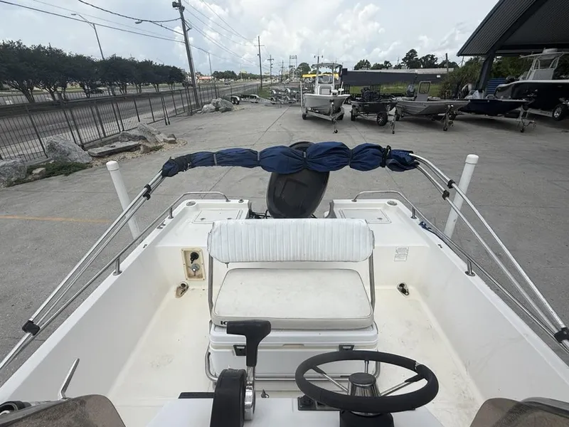 Slide: The Image of Key West 196 Bay Reef boat, 2001 model, parked outdoors with steering wheel and seating visible. - 7