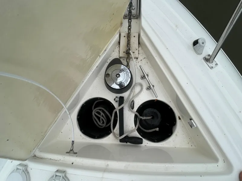 Slide: The Image of 2006 Cruisers Yachts 300 Express anchor locker with ropes and winch. - 16