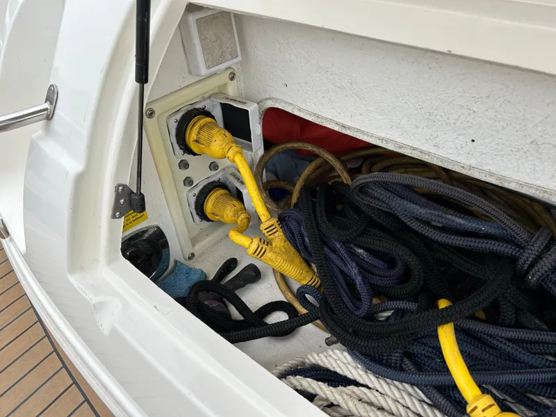Slide: The Image of Storage compartment with cables and ropes on a 2006 Cruisers Yachts 300 Express. - 18