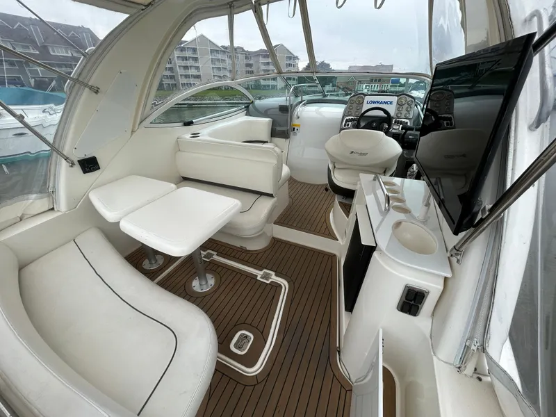 Slide: The Image of 2006 Cruisers Yachts 300 Express interior with white seating and wood flooring. - 19