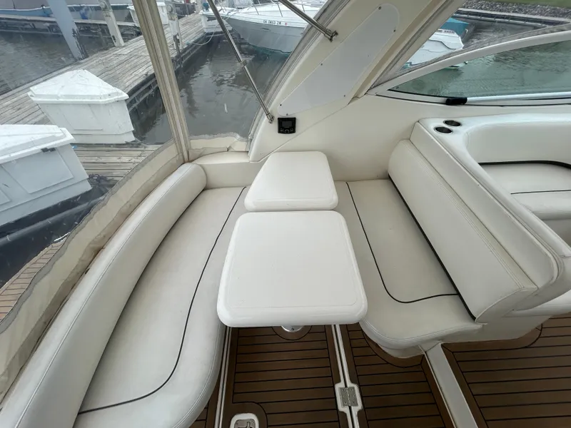 Slide: The Image of 2006 Cruisers Yachts 300 Express interior with white seating and wooden flooring. - 21