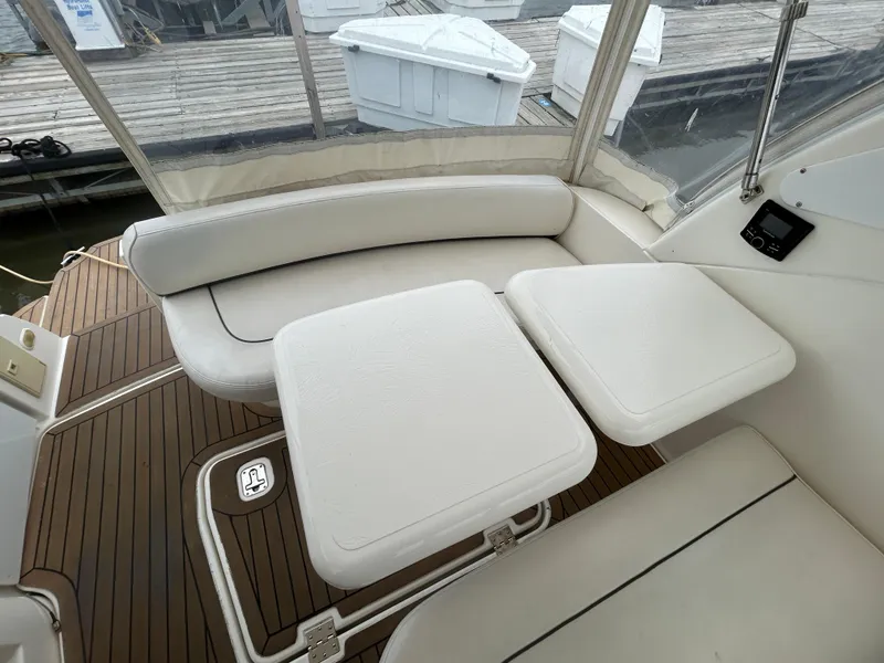 Slide: The Image of 2006 Cruisers Yachts 300 Express interior with white seating and wooden flooring. - 23